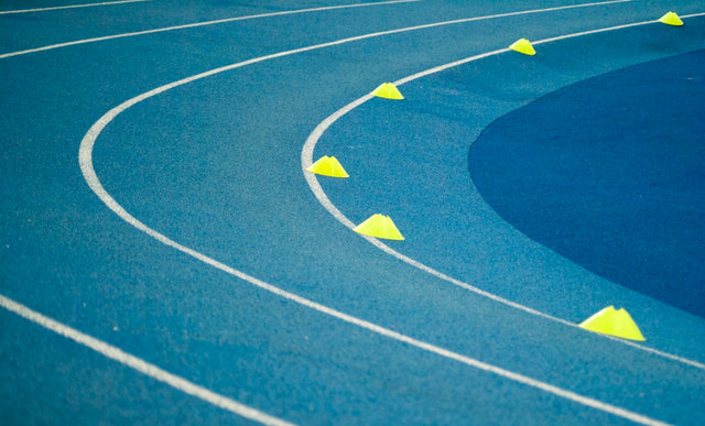 blue curved track field at daytime