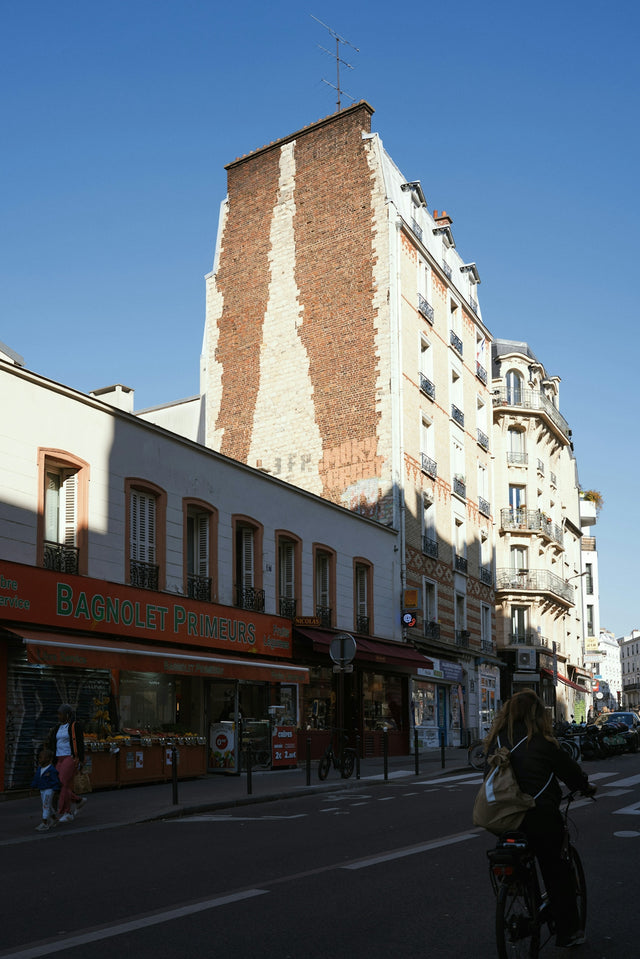 Street view of buildings with a person cycling