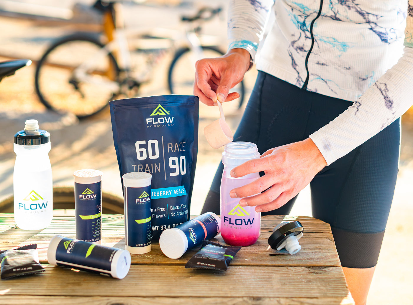 An athlete preparing for a race by mixing a Flow Formulas endurance mix.