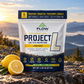 Project L Lemon Burst pouch in a mountain setting with fresh lemon.